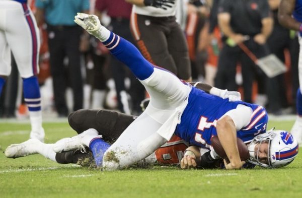 Buffalo Bills quarterback Josh Allen is sacked by Cleveland Browns defensive back Derrick Kindred during the first half.