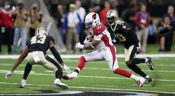 Arizona Cardinals running back David Johnson is defended by New Orleans Saints defensive back Marcus Williams and cornerback Ken Crawley during the first quarter.