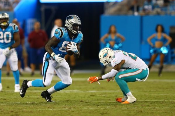 Carolina Panthers tight end Ian Thomas runs after a catch while Miami Dolphins defensive back Maurice Smith attempts to the tackle in the third quarter.