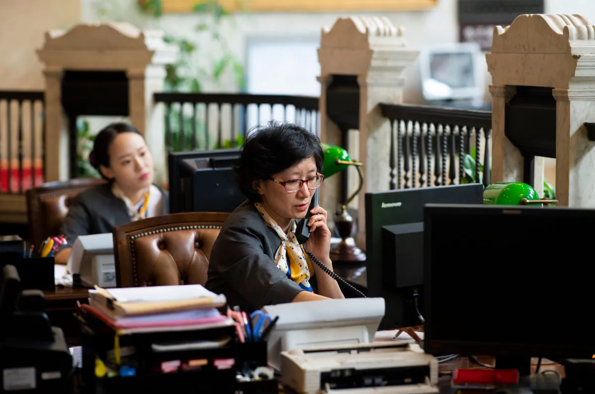 Employees work at a bank in Shanghai on Aug. 8, 2018. (Johannes Eisele / AFP/Getty Images)