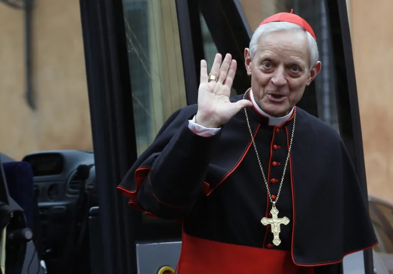 FILE PHOTO: Cardinal Donald William Wuerl from U.S. waves as he arrives for a meeting at the Synod Hall in the Vatican March 7, 2013. (Reuters/Alessandro Bianchi)