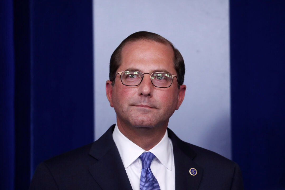 U.S. Health and Human Services Secretary Alex Azar listens to U.S. White House Press Secretary Sarah Huckabee Sanders introduce him during the daily briefing at the White House in Washington, U.S., May 11, 2018. REUTERS/Leah Millis