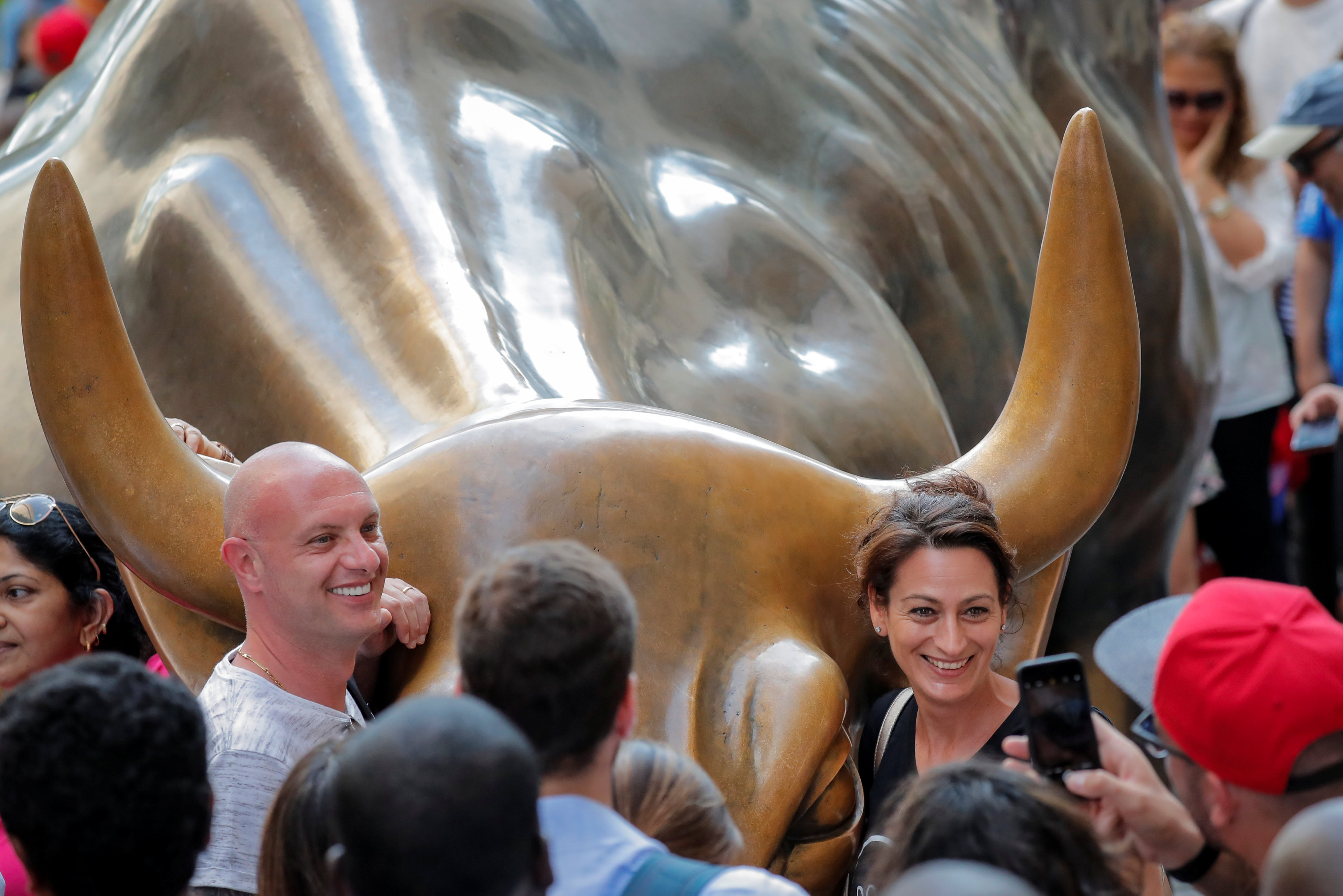 Tourists gather around the Charging Bull.