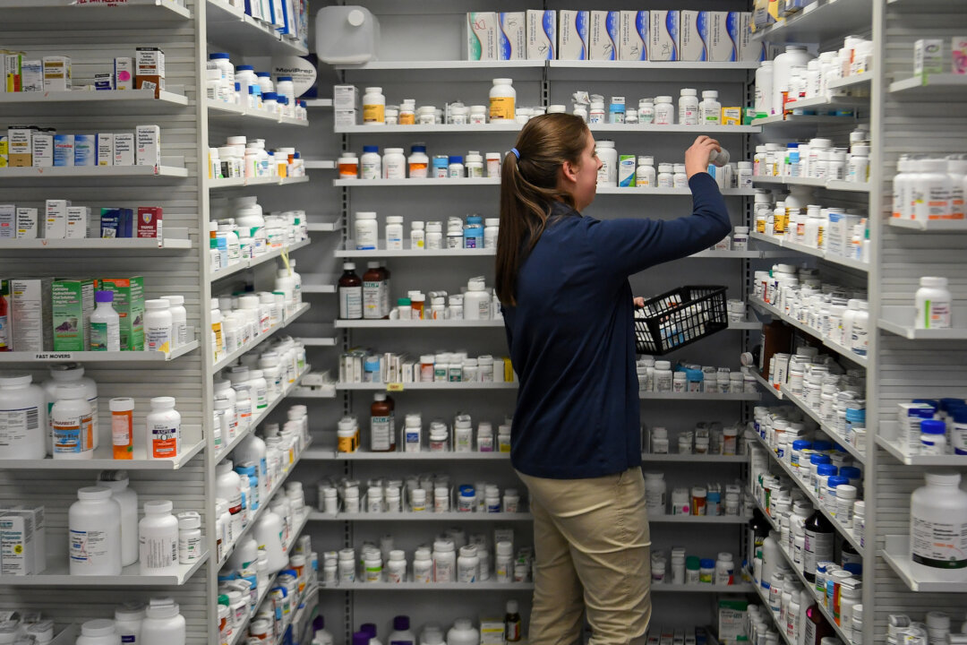 A technician stocks the shelves of the pharmacy at White House Clinic in Berea, Kentucky on Feb. 7, 2018. (REUTERS/Bryan Woolston)