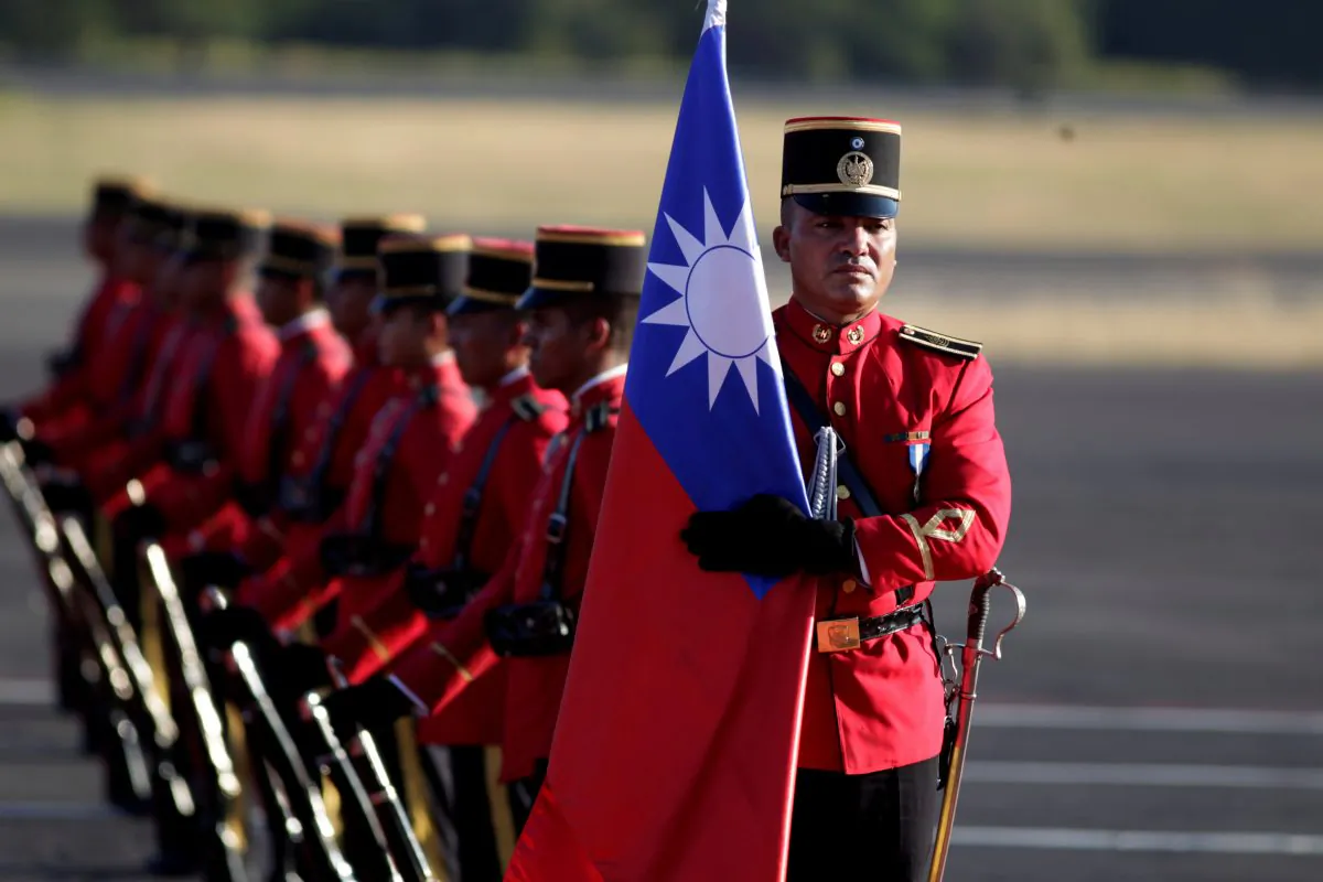  A honor guard holds a Taiwan flag before the arrival of Taiwan's President Tsai Ing-wen at the Oscar Arnulfo Romero International Airport in San Luis Talpa, El Salvador, on Jan. 12, 2017. (Jose Cabezas/Reuters)