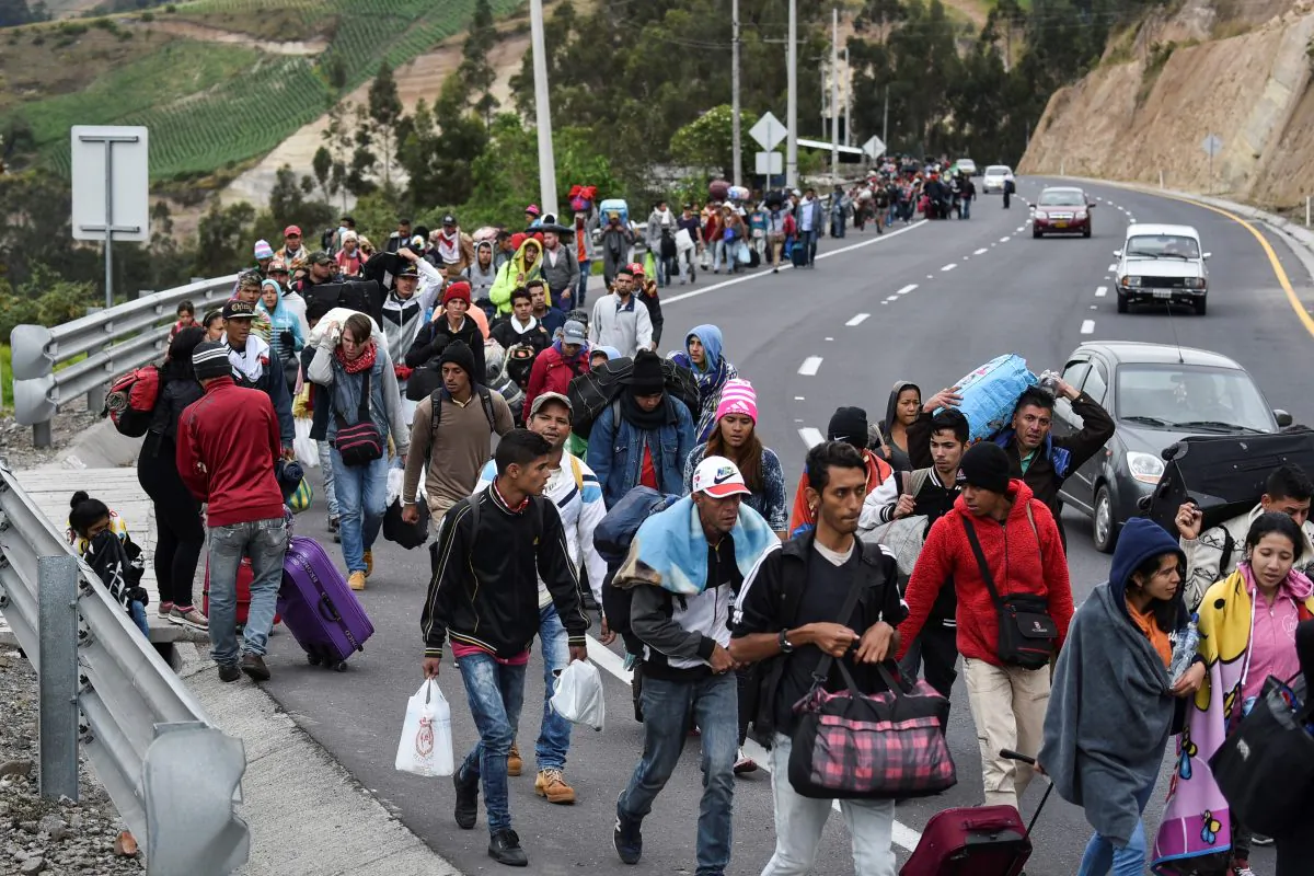Venezuelan migrants heading to Peru walk along the Panamerican highway in Tulcan, Ecuador on Aug. 21, 2018. Ecuador announced on August 16 that Venezuelans entering the country would need to show passports from August 18 onwards, a document many are not carrying. (LUIS ROBAYO/AFP/Getty Images)