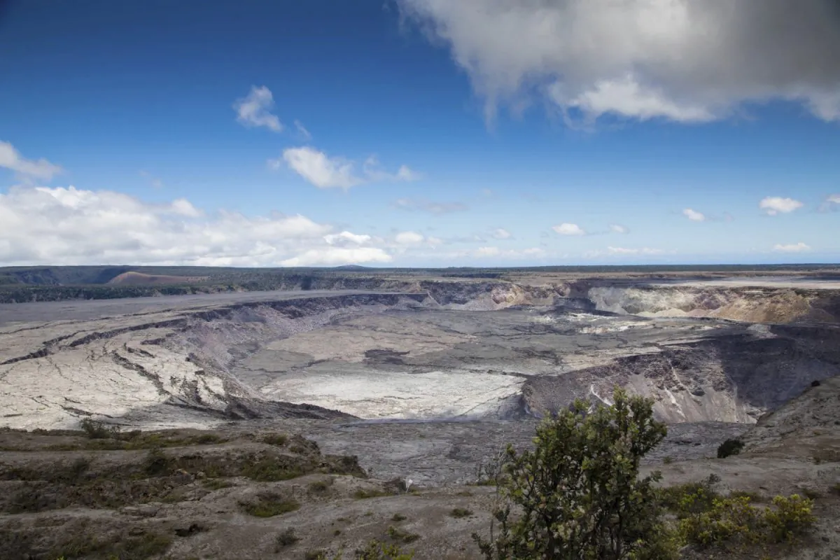 This National Park Service photo shows Halemaumau Crater, which has quadrupled in size since May, and Kilauea Caldera at Kilauea volcano's summit inside Hawaii Volcanoes National Park in Hawaii on Friday, Aug. 17, 2018. (Janice Wei/National Park Service via AP)