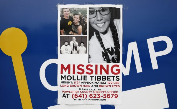 A poster for missing University of Iowa student Mollie Tibbetts hangs on the front door of a local business, Tuesday, Aug. 21, 2018, in Brooklyn, Iowa.