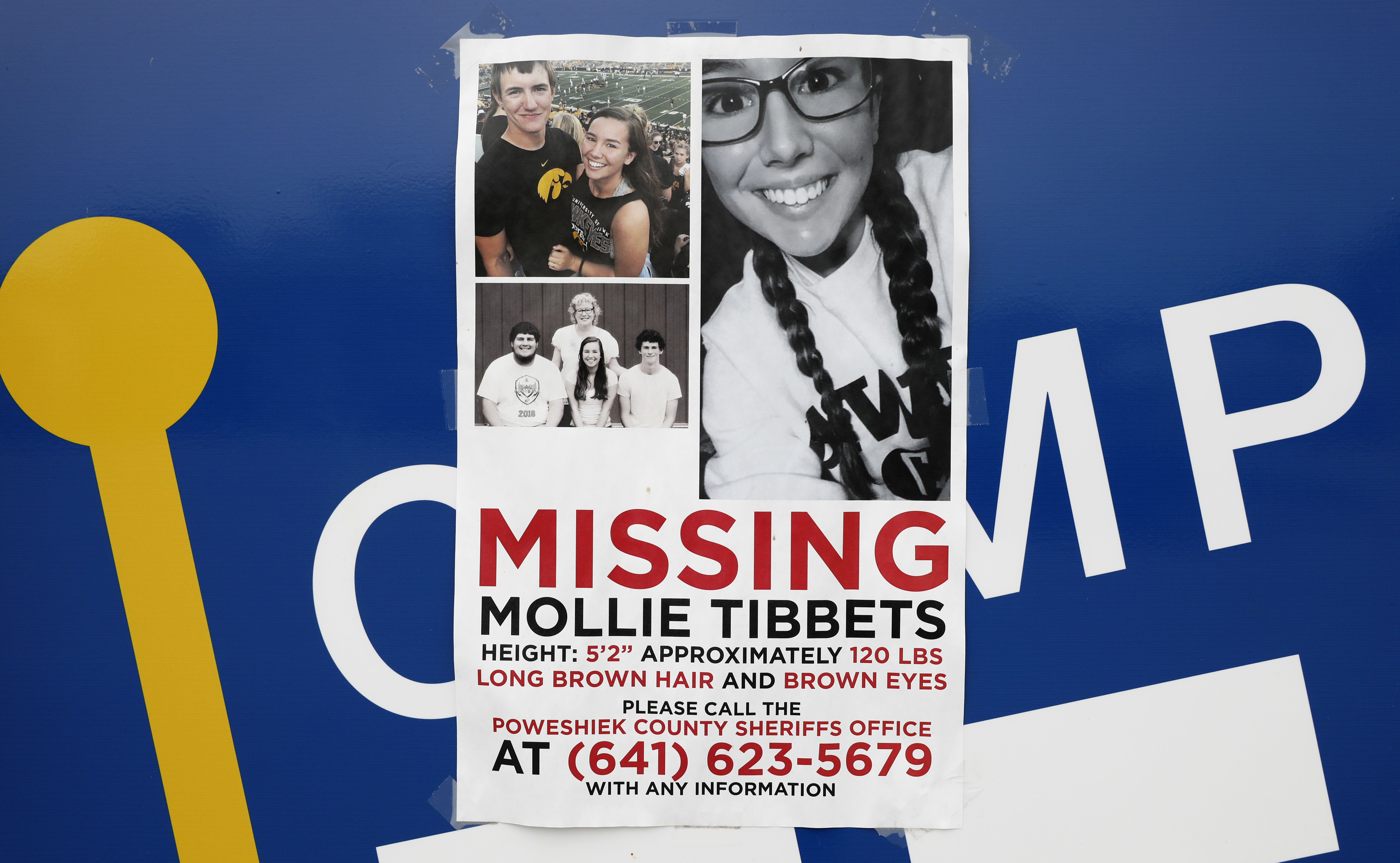 A poster for missing University of Iowa student Mollie Tibbetts hangs on the front door of a local business, Tuesday, Aug. 21, 2018, in Brooklyn, Iowa.