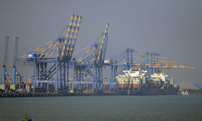 A container ship (R) docked at India's Adani Port Special Economic Zone (APSEZ) in Mundra on December 21, 2016. Arthur Wiegenfeld recommends the United States increase trade with India. (SAM PANTHAKY/AFP/Getty Images)
