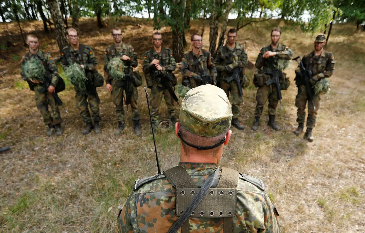 German Bundeswehr armed forces recruits receive a debriefing by an instructor during a drill at a military training area in Viereck, Germany, on Aug. 8, 2018. (Fabrizio Bensch/Reuters)
