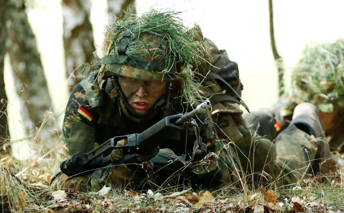 A German Bundeswehr armed forces recruit takes position during a drill at a military training area in Viereck, Germany, on Aug. 8, 2018. (Reuters/Fabrizio Bensch)