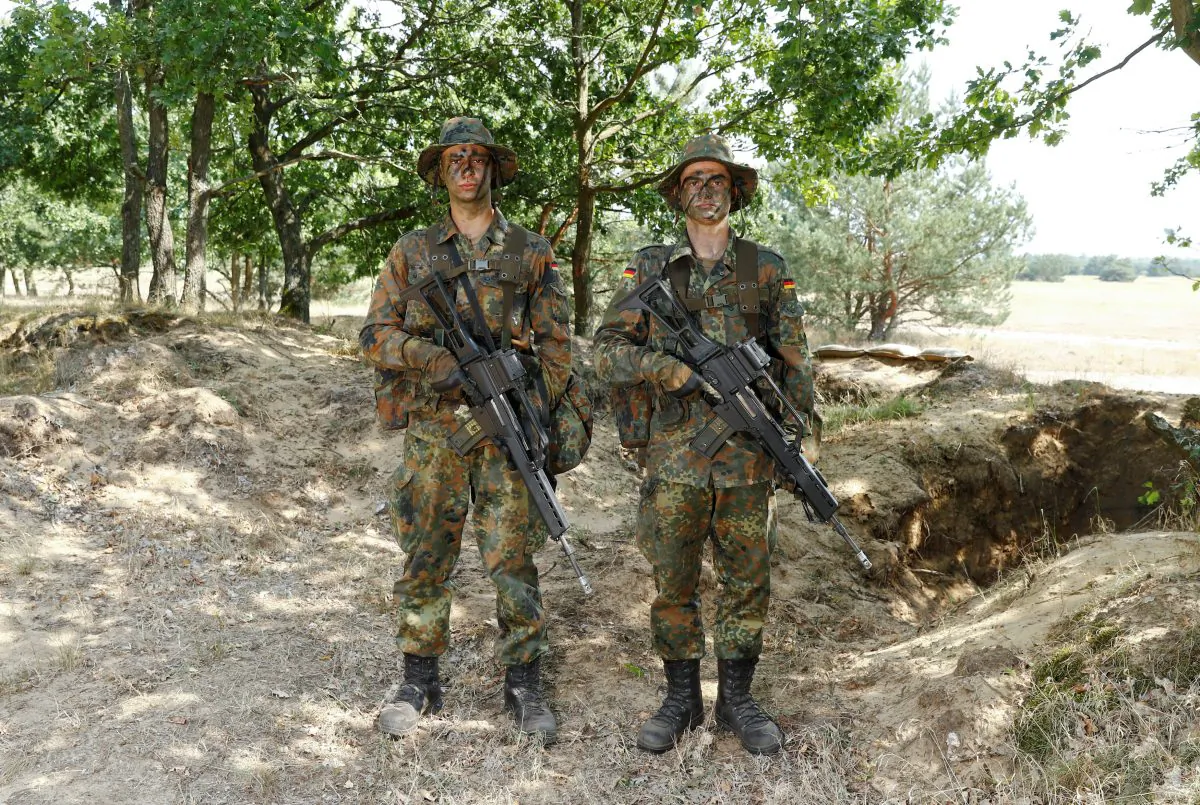 German Bundeswehr armed forces recruits Marlon S. (L) and Max H. of the Mechanized Infantry Battalion 411 during a drill at a military training area in Viereck, Germany, on Aug. 8, 2018. (Reuters/Fabrizio Bensch)