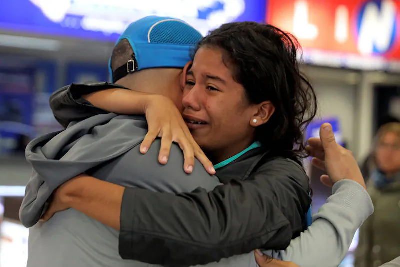 A Venezuelan migrant hugs her brother after arriving from Cucuta of Colombia, during a five day trip, at the bus terminal in Lima, Peru August 24, 2018. (Reuters/Guadalupe Pardo)