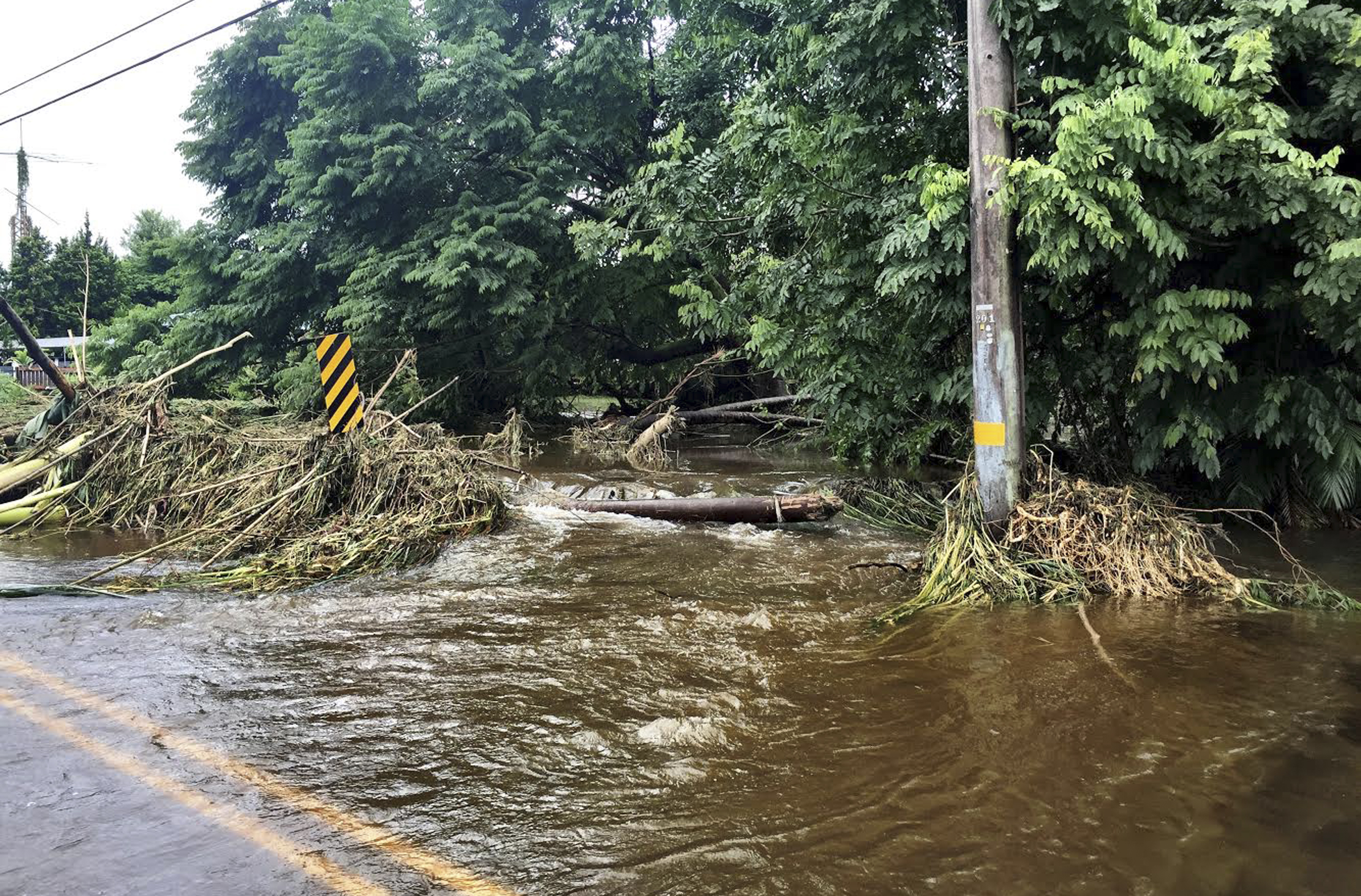 In this photo provided by Jessica Henricks, is flooding and damage from Hurricane Lane Friday, Aug. 24, 2018, near Hilo, Hawaii. (Jessica Henricks via AP)