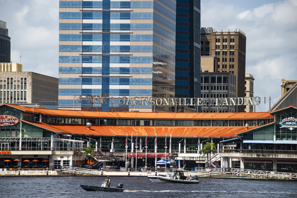 The coast guard patrols the St John's river outside of the Jacksonville Landing in Jacksonville, Florida on Aug. 26, 2018. Florida authorities are reporting multiple fatalities after a mass shooting at the riverfront mall in Jacksonville that was hosting a video game tournament. (AP Photo/Laura Heald)
