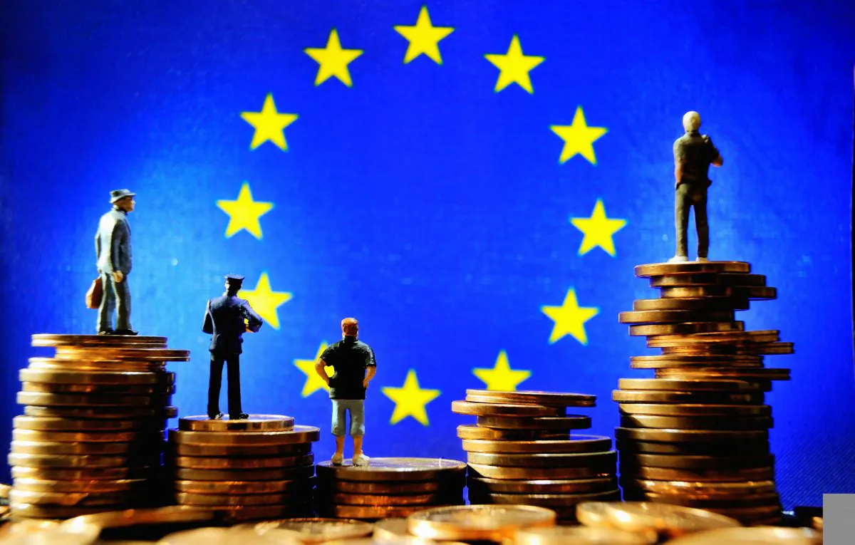 Euro coins in front of the European Union flag. (Philippe Huguen/AFP/Getty Images)