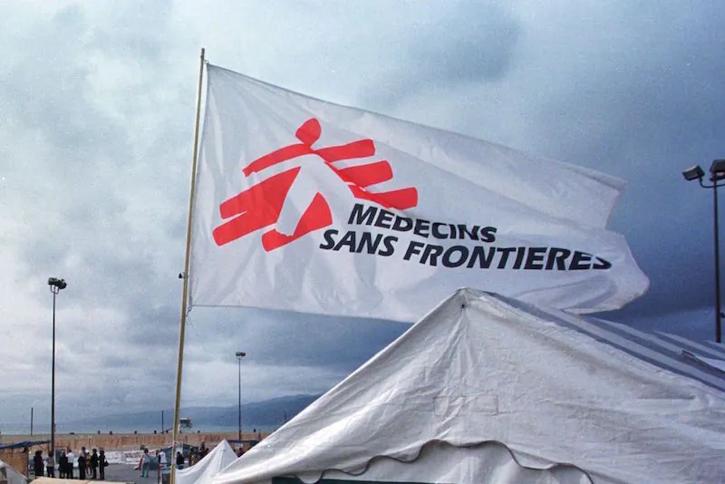 File Photo: A flag with the logo of Medecins Sans Frontieres (Doctors Without Borders), an international humanitarian aid organisation, flies over a mock refugee camp set up along the boardwalk of Santa Monica beach in California on Oct. 26, 2000. (Lee Celano/AFP/Getty Images)