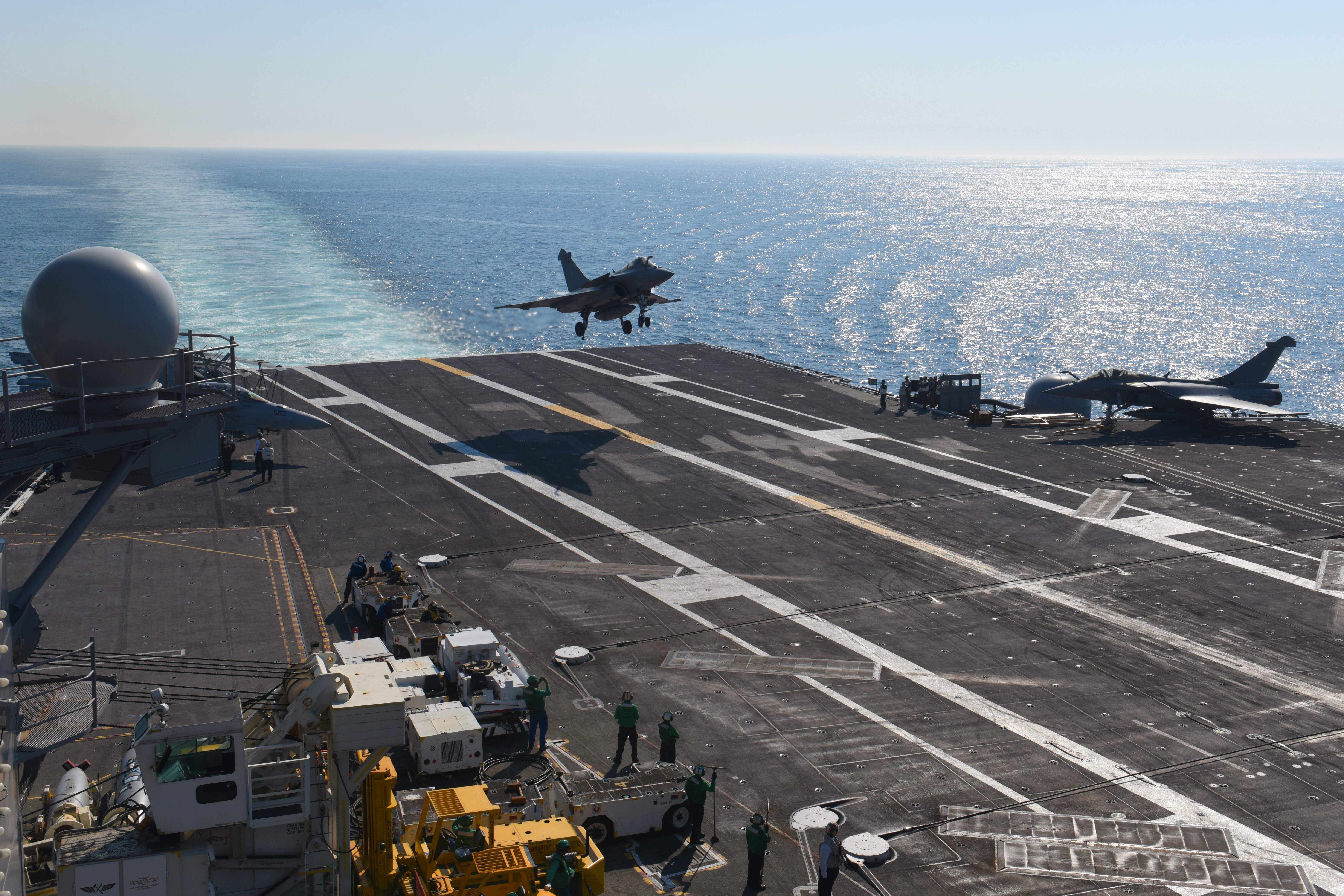 A fighter jet lands the deck of the USS George H.W. Bush aircraft carrier on May 11, 2018 in the Atlantic Ocean. (ERIC BARADAT/AFP/Getty Images)