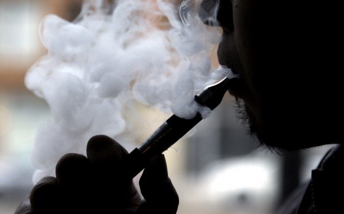 In this April 23, 2014, photo, a man smokes an electronic cigarette in Chicago. (Nam Y. Huh/AP Photo/File)