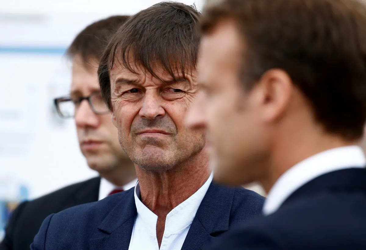 Nicolas Hulot, French environment minister, looks over toward President Emmanuel Macron as they visit the Cap Frehel peninsula in northern Brittany, France, on June 20, 2018. (Stephane Mahe/Reuters/File Photo)