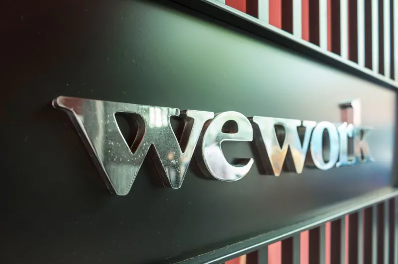 A logo of U.S. co-working firm WeWork is pictured during a signing ceremony in Shanghai, China April 12, 2018. Picture taken April 12, 2018. (Jackal Pan via Reuters).