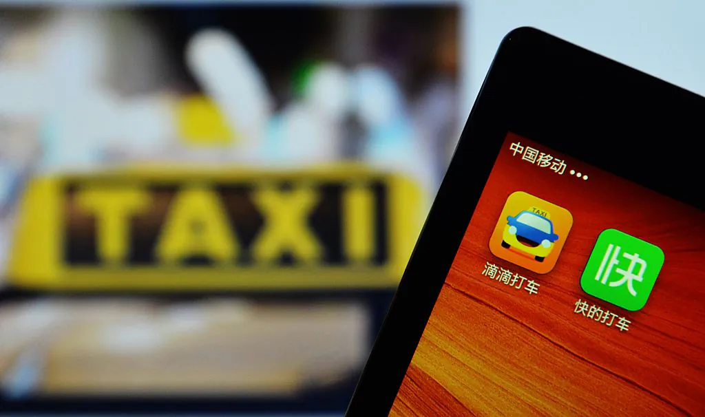 A smartphone shows the two apps, Kuaidi Dache and Didi Dache being display in Hangzhou, China's Zhejiang Province on Feb. 14, 2015. (STR/AFP/Getty Images)