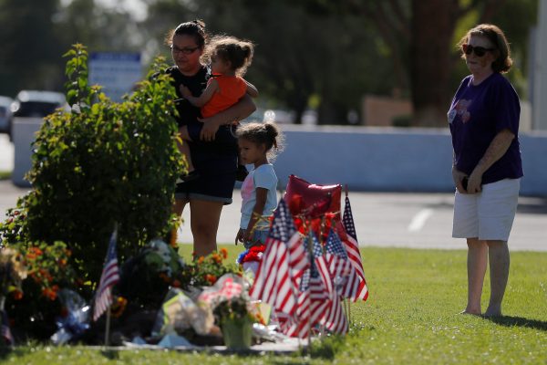 People visit the makeshift memorial outside the funeral home where John McCain's body remains