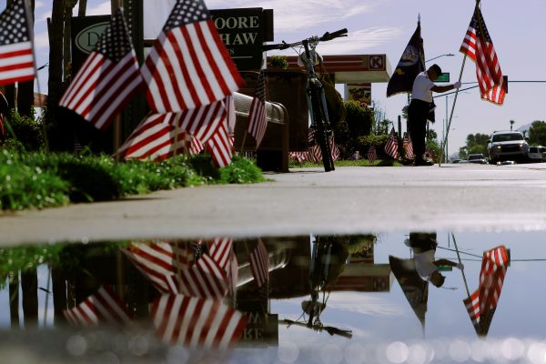An honor guard member stands outside the funeral home where John McCain's body remains
