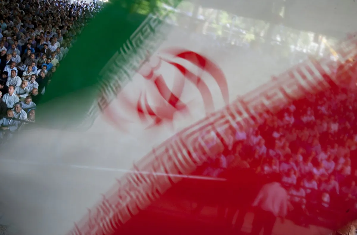 An Iranian flag flutters as worshippers attend Friday prayers in Tehran. (Reuters/Morteza Nikoubazl)