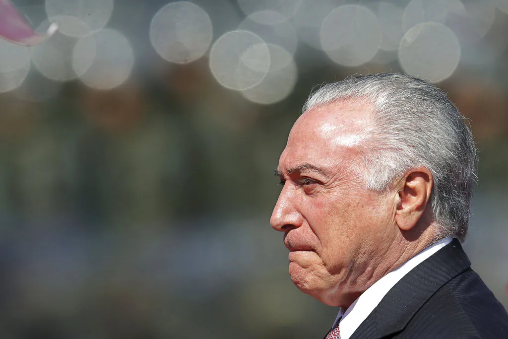 Brazil's President Michel Temer arrives to attend Soldier's Day ceremonies at the Army's headquarters in Brasilia, Brazil, Friday, Aug. 24, 2018. The Brazilian Army celebrates throughout Brazil the Day of the Soldier, honoring the soldiers killed in combat. (AP Photo/Eraldo Peres)
