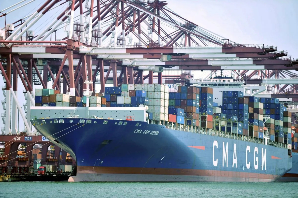 A container ship is docked at a port in Qingdao in eastern China’s Shandong Province on July 6, 2018. (Chinatopix via AP)