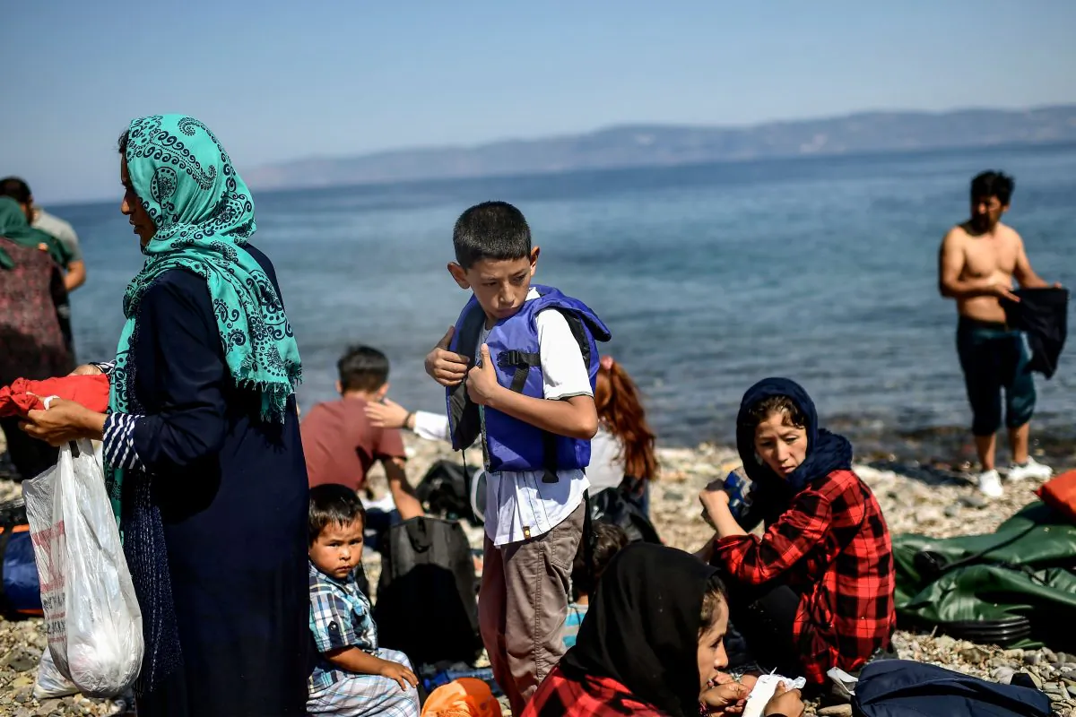 Migrants from Afghanistan arrive after crossing the Aegean Sea from Turkey with a dinghy on the Greek Mediterranean island of Lesbos on August 6, 2018. (Aris Messinis/AFP/Getty Images)