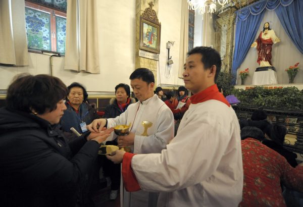 Chinese worshippers attend a Holy Communion during Christmas Mass at a Catholic church in Beijing on December 24, 2009. About 15 million Protestants and five million Catholics worship at official churches, according to China's official data. (Liu Jin/AFP/Getty Images)