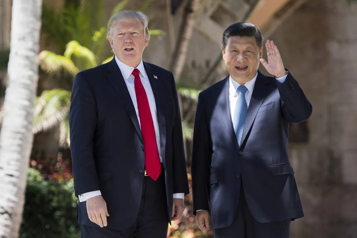 Chinese leader Xi Jinping (R) waves to the press as he walks with U.S. President Donald Trump at the Mar-a-Lago estate in West Palm Beach, Fla., on April 7, 2017. (Jim Watson/AFP/Getty Images)