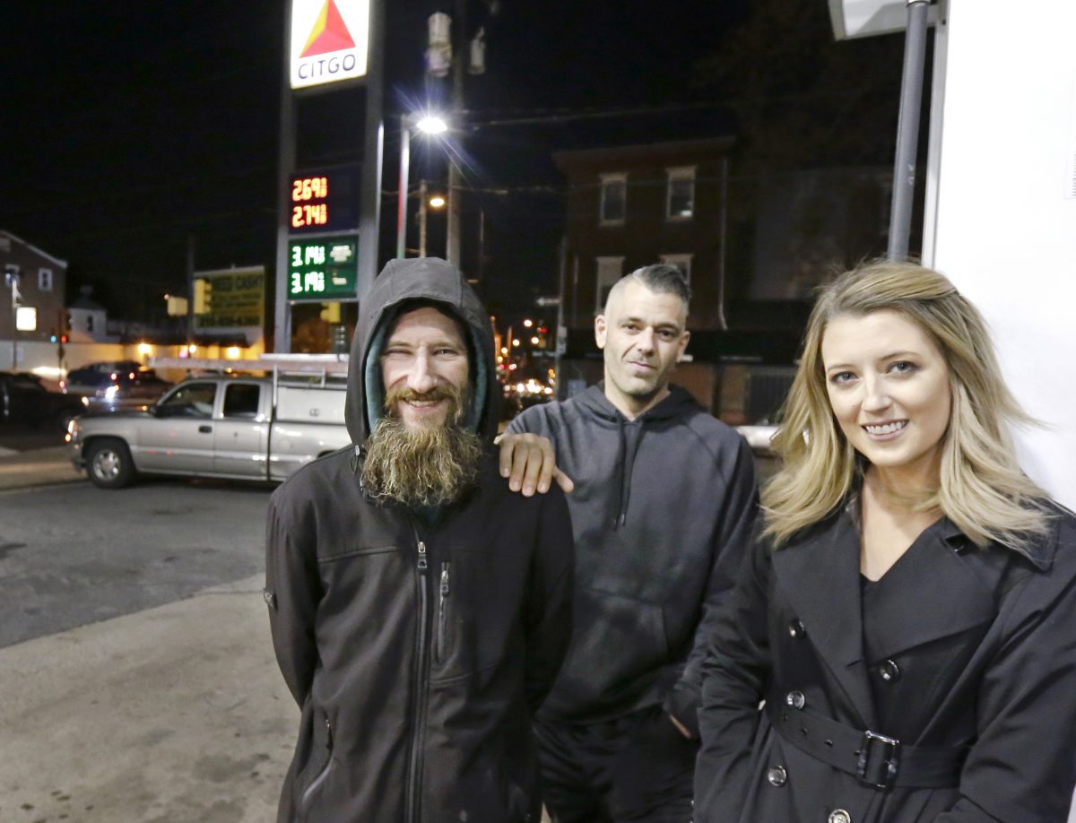 Johnny Bobbitt (L), Kate McClure (R) and McClure's boyfriend Mark D'Amico pose at a Citgo station in Philadelphia.