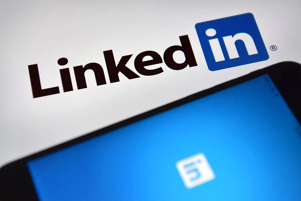 LinkedIn logos are displayed on an iPhone and computer screen in London, England, on Aug. 3, 2016. (Carl Court/Getty Images)