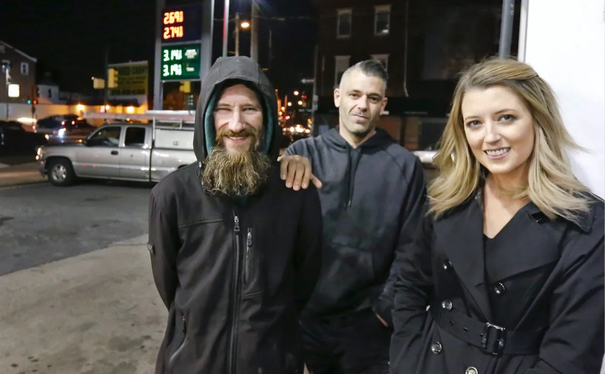 Johnny Bobbitt (L), Kate McClure (R) and McClure's boyfriend Mark D'Amico pose at a Citgo station in Philadelphia.  McClure and D'Amico raised more than $400,000 for Bobbitt, a homeless man, but withheld the funds for fear he would buy drugs. But on Aug. 30 a New Jersey judge issued an order compelling them to hand over the funds. (Elizabeth Robertson/The Philadelphia Inquirer via AP)
