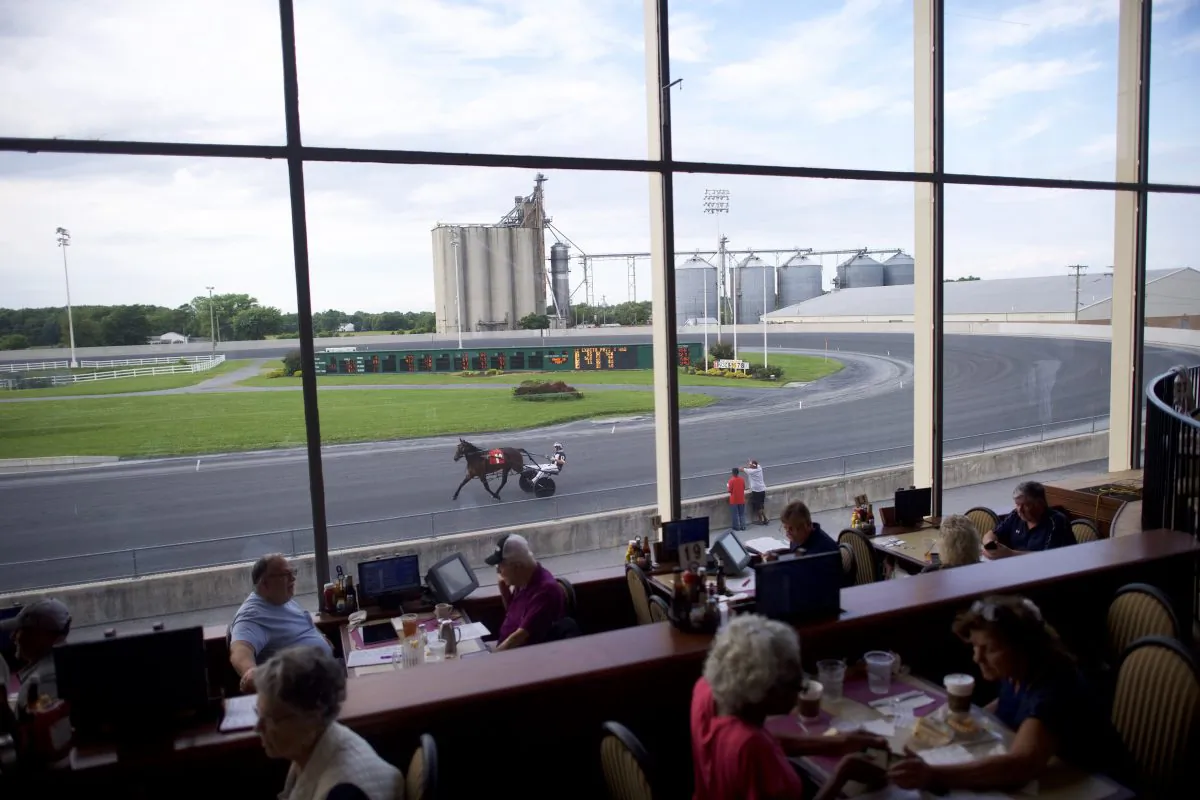 Bettors dine as horses warm up before races at Harrington Raceway and Casino in Harrington, Delaware on June 5, 2018. (Mark Makela/Getty Images)