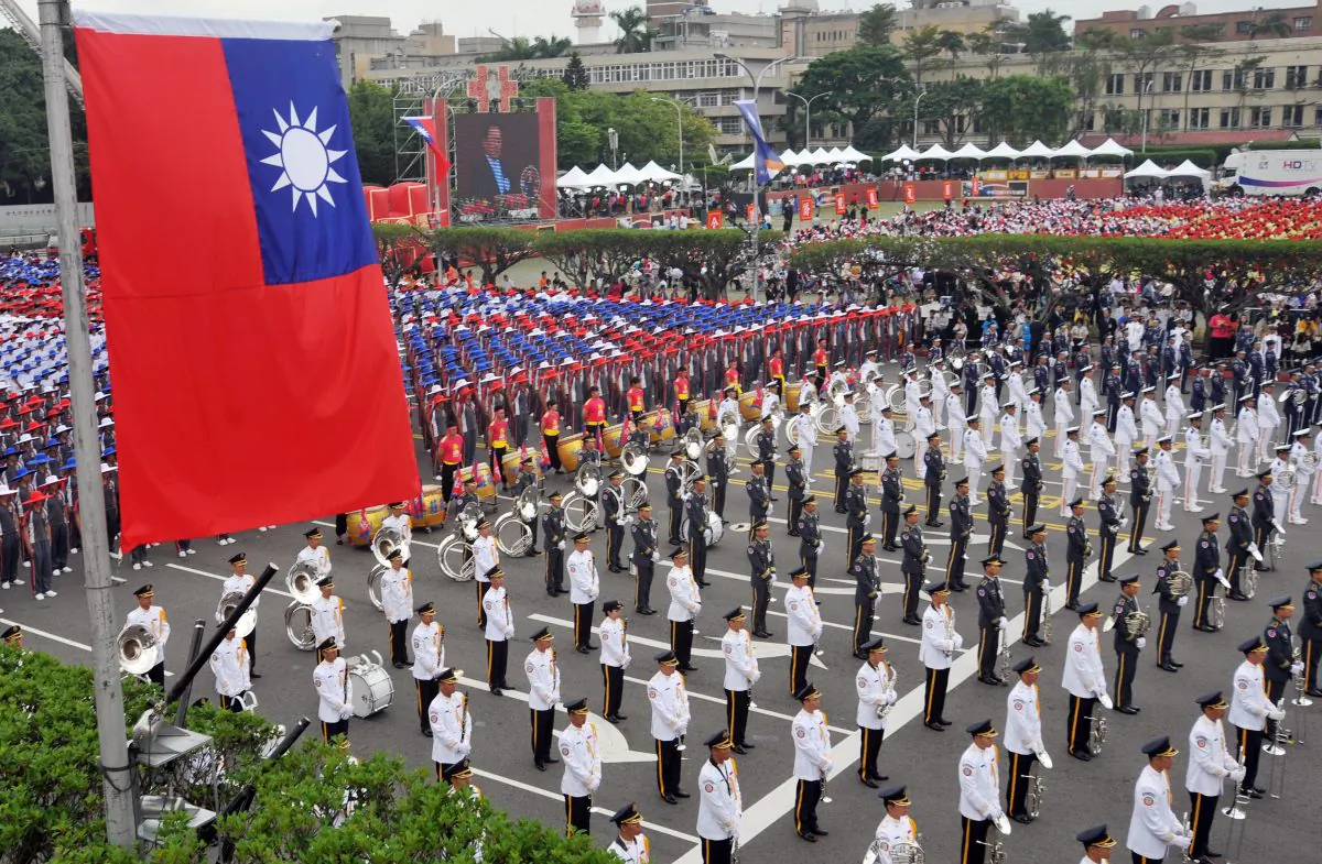 Members of a Taiwanese military band and people wearing hats in the colors of Taiwan's national flag take part in National Day celebrations in front of Taiwan's Presidential Office in Taipei on Oct. 10, 2012. (Mandy Cheng/AFP/Getty Images)