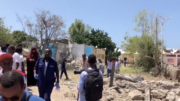 People look at debris of blast