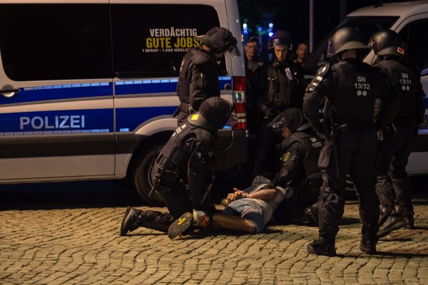 Police arrest a protester in Chemnitz