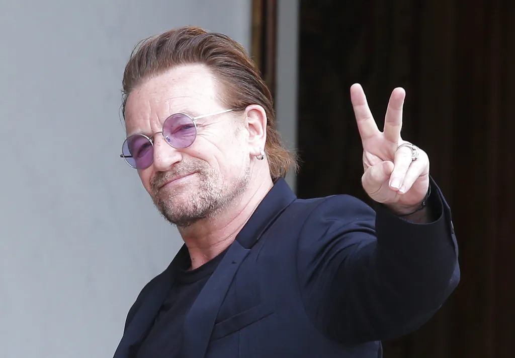 U2 singer Bono makes a peace sign as he arrives for a meeting at the Elysee Palace, in Paris, France on July 24, 2017. (AP/Michel Euler/ file)