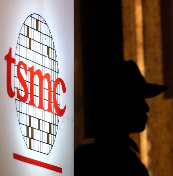A security staff stands next to a logo of the Taiwan Semiconductor Manufacturing Corp., during the investors conference in Taipei on July 16, 2014. (Sam Yeh/AFP/Getty Images)
