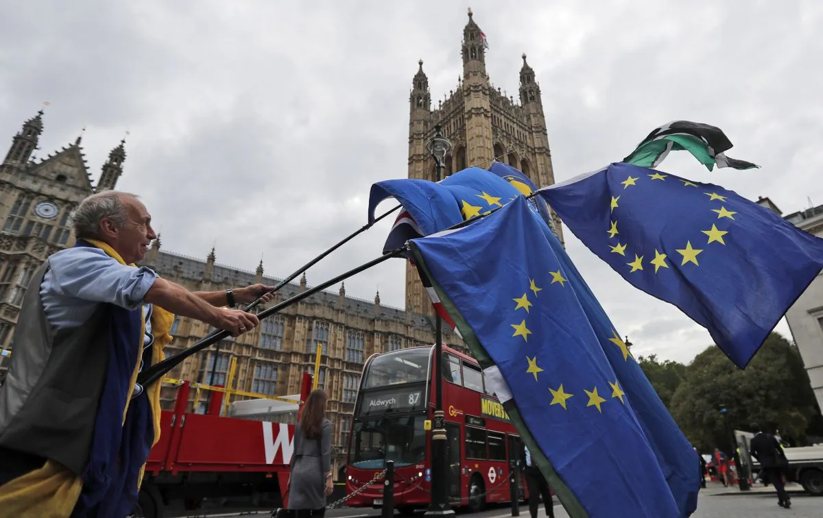 A protestor waves EU flags in front of the Houses of Parliament in London on Sept. 4. (AP Photo/Frank Augstein)