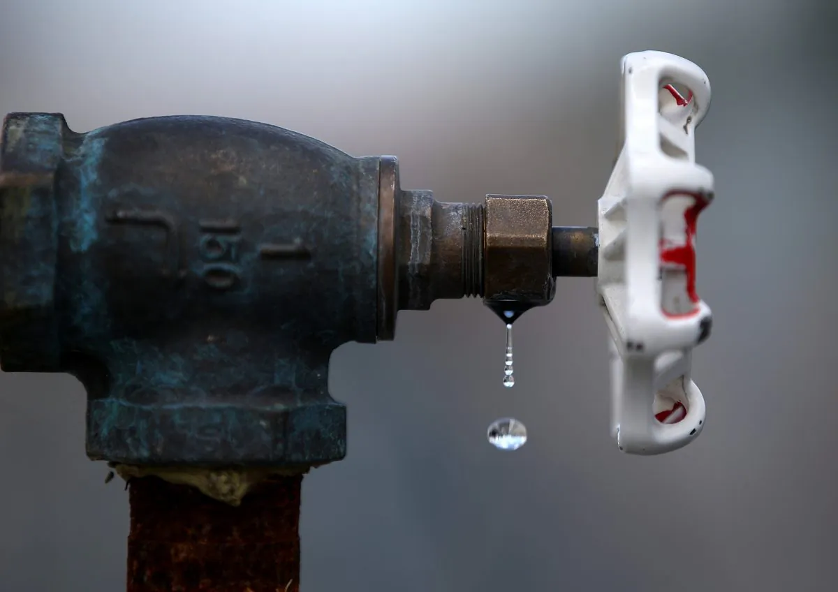 Water drips from a faucet at the Dublin San Ramon Services District (DSRSD) residential recycled water fill station in Pleasanton, Calif., on April 8, 2015. (Justin Sullivan/Getty Images)
