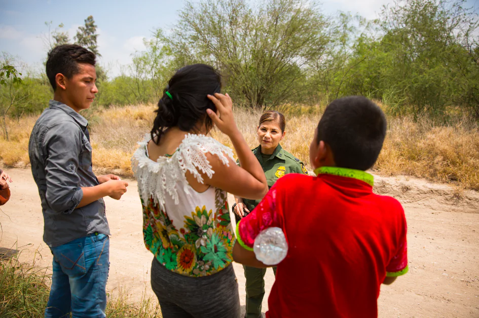 Supervisory Border Patrol agent Marlene Castro speaks to a group of unaccompanied minors who just crossed the Rio Grande illegally from Mexico into the United States, in Hidalgo County, Texas, on May 26, 2017. (Benjamin Chasteen/The Epoch Times)