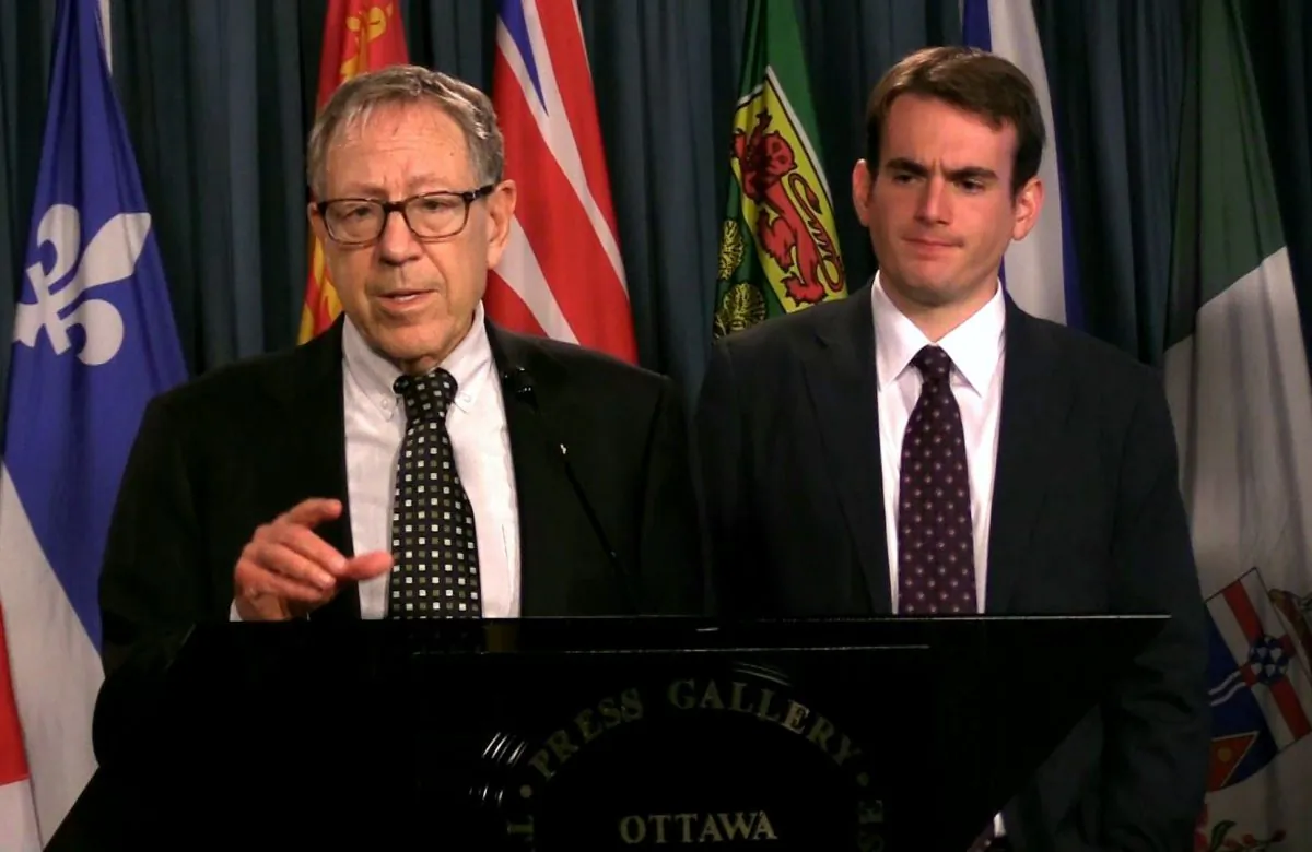 Irwin Cotler (L), chair of the Raoul Wallenberg Centre for Human Rights, speaks at a press conference on Parliament Hill in Ottawa on Aug. 30, 2018. With him is Brandon Silver, the director of policy and projects at the centre. (Limin Zhou/The Epoch Times)