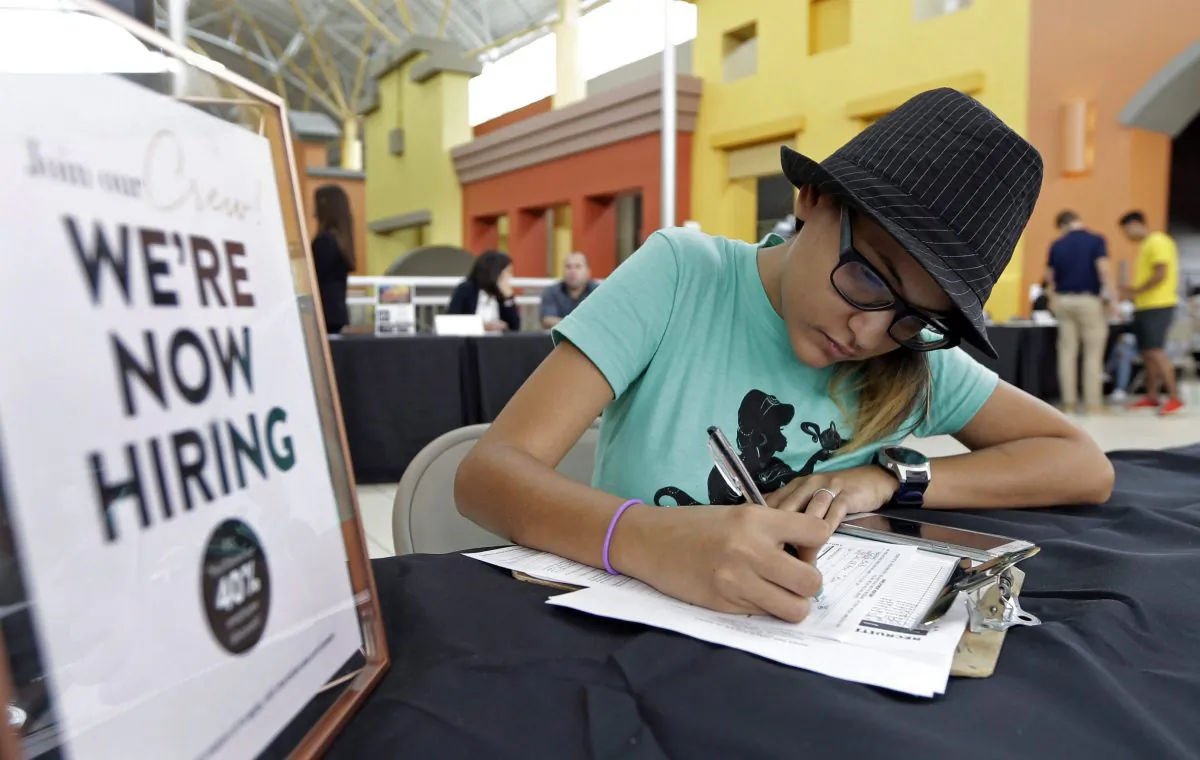 A job seeker fills out an application at a job fair in this file photo. Canadian small- and medium-sized firms are desperate to hire more young workers.(AP Photo/Alan Diaz, File)