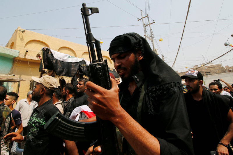 Mourners carry the coffin of a protester